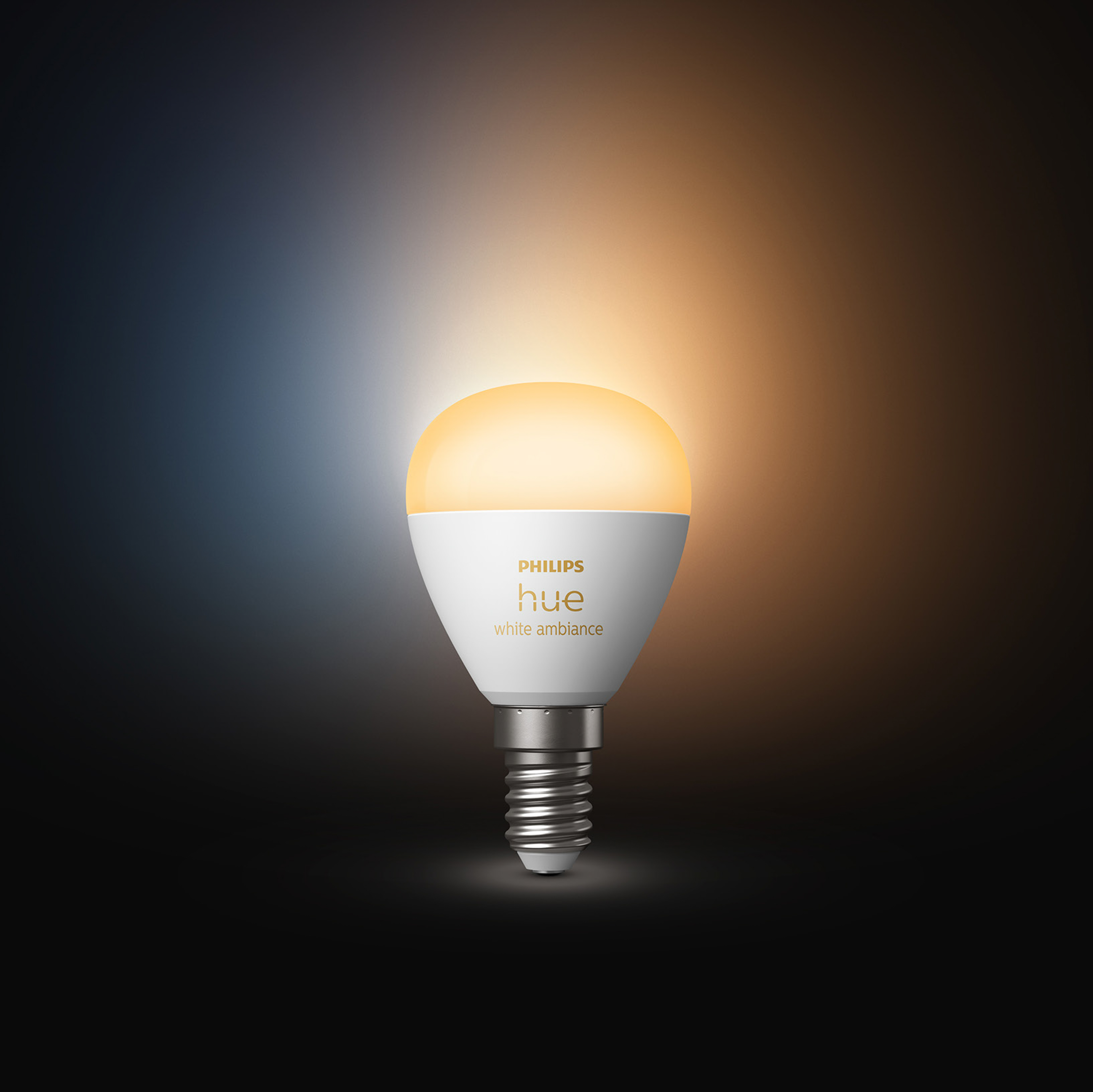 Żarówka Philips Hue, biała ze srebrną podstawą i żółtym blaskiem.