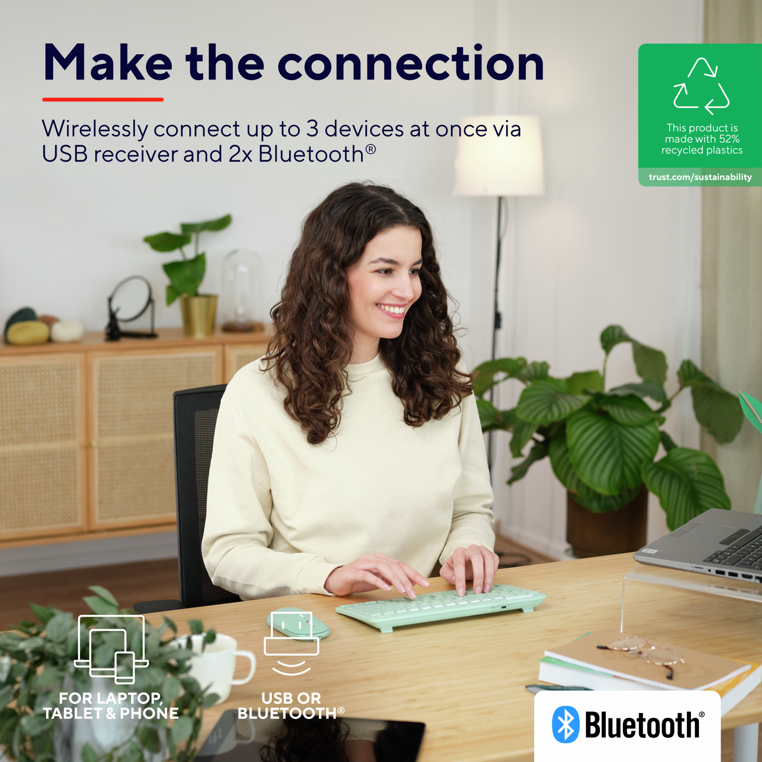 Kobieta używająca klawiatury z zielonym laptopem, z tekstem o połączeniu przez USB i Bluetooth.