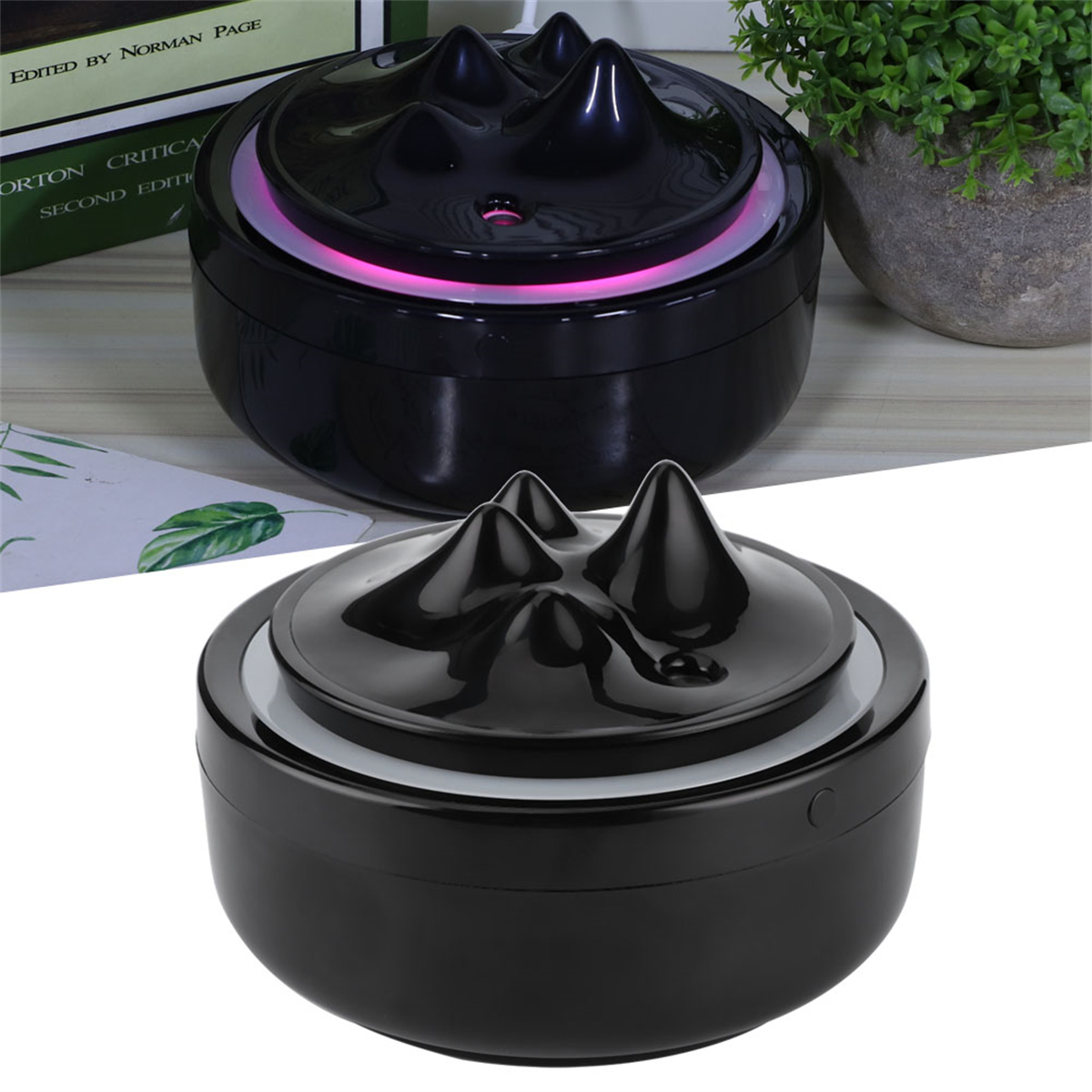 Zwei schwarze Aromatherapie-Diffusoren, einer über dem anderen. Sie sind schwarz und haben ein Bergdesign.