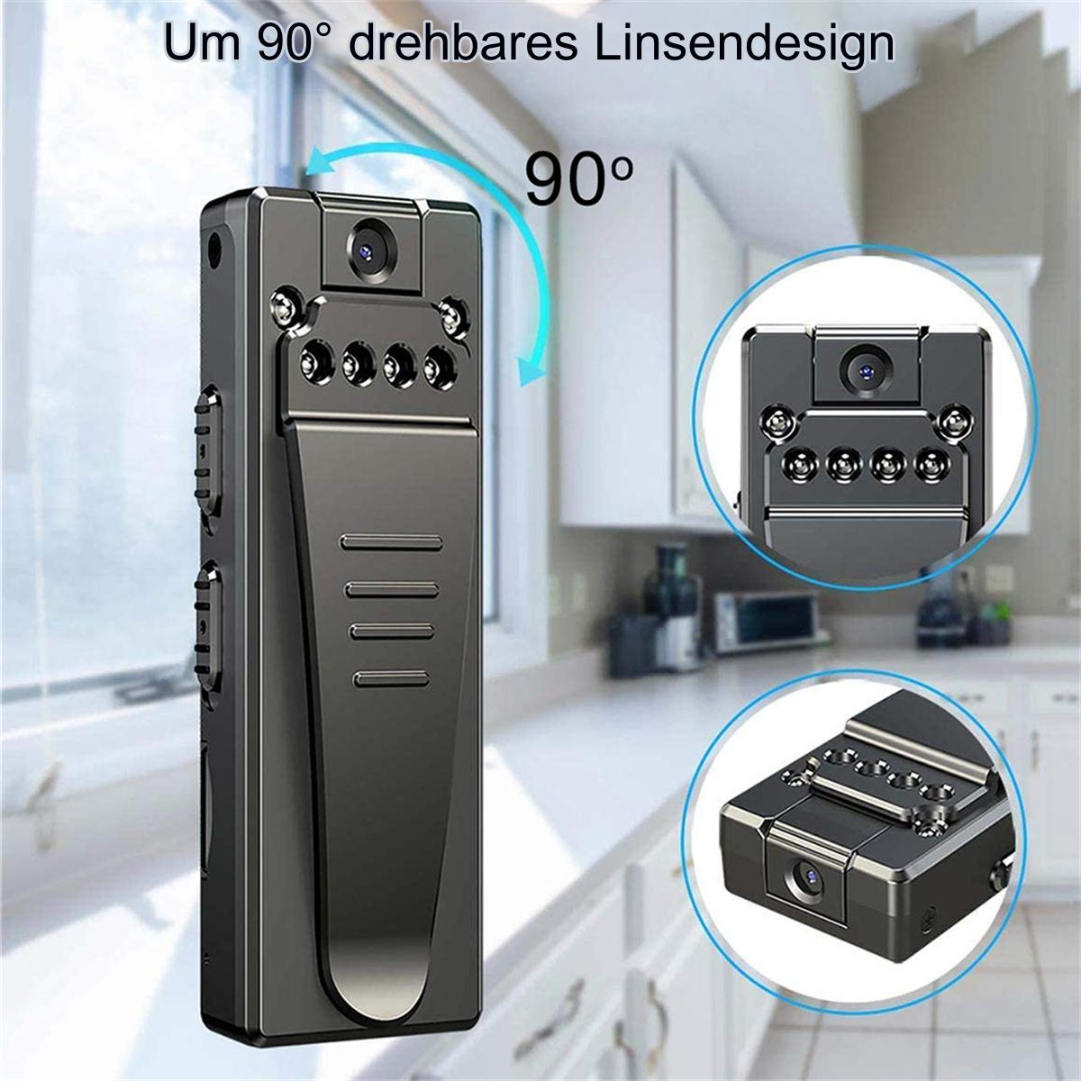 Eine kleine schwarze Kamera mit drehbarem Objektiv, vor einem verschwommenen Küchenhintergrund.
