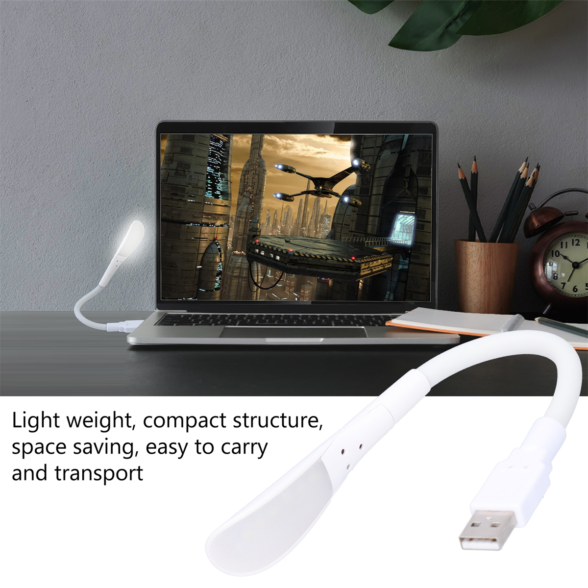 Eine flexible weiße USB-LED-Lampe steht auf einem Schreibtisch neben einem Laptop mit Stadtansicht.