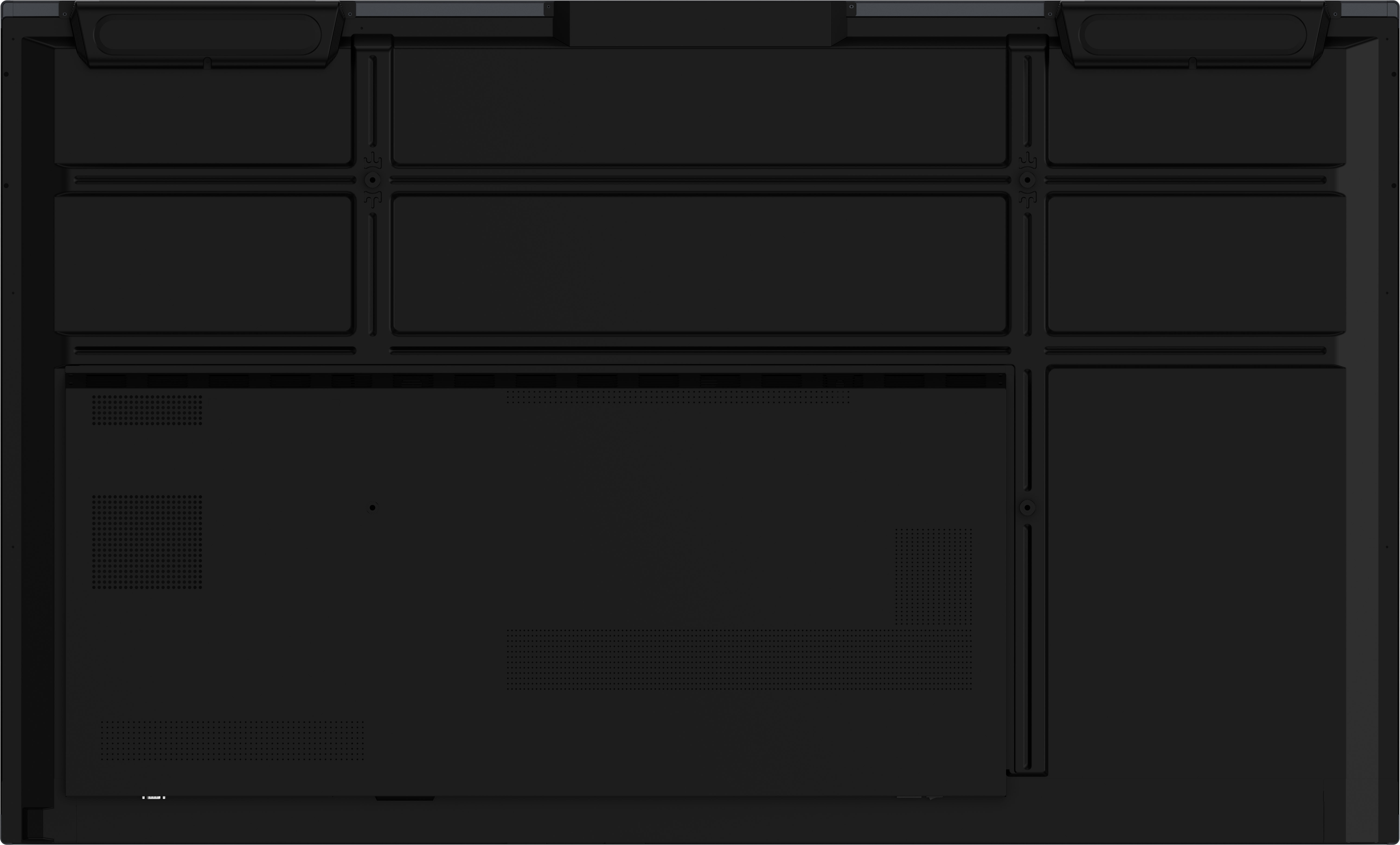 The bottom side of a black laptop, showing vents and structural details.
