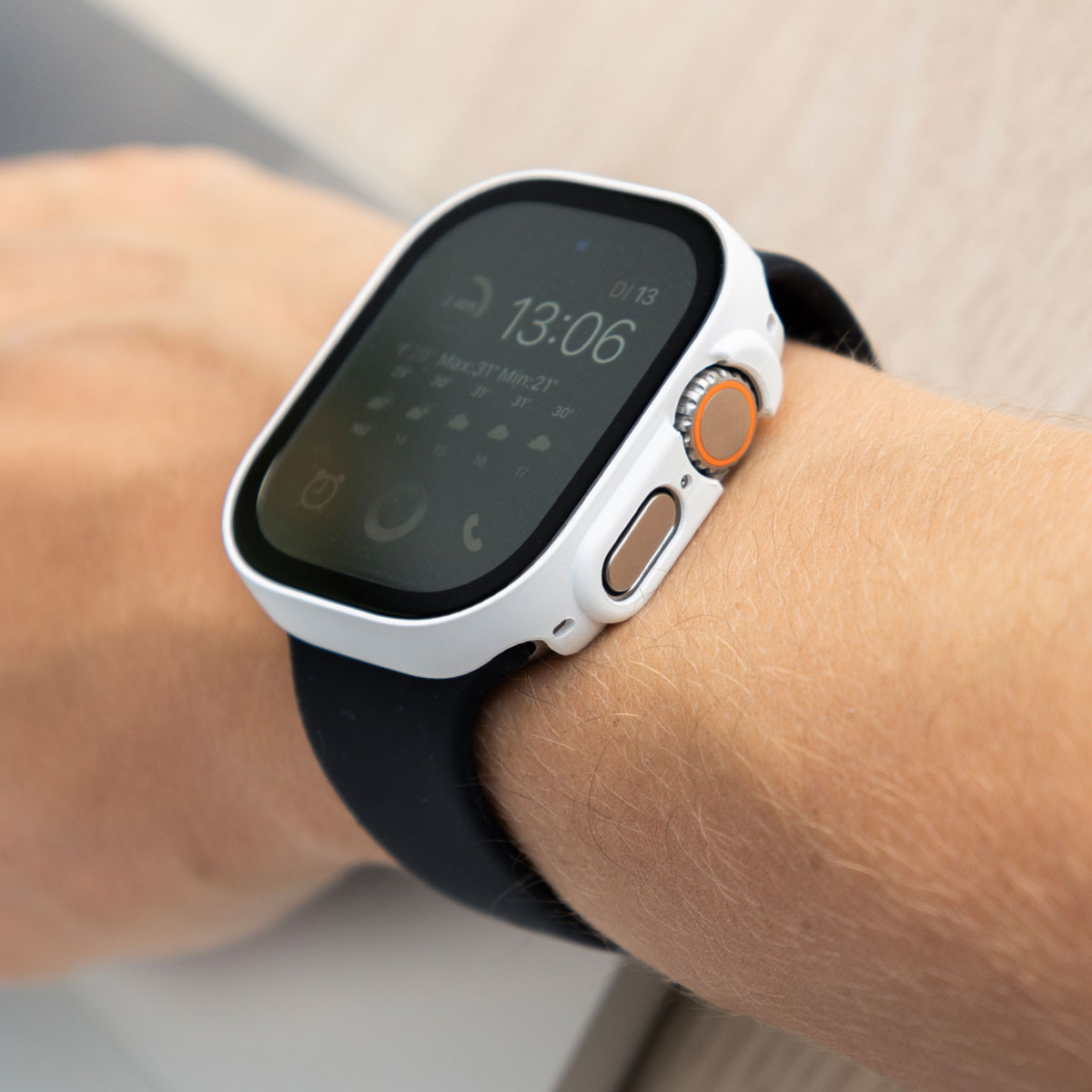 A person's wrist with a smart watch. The watch is white and black.