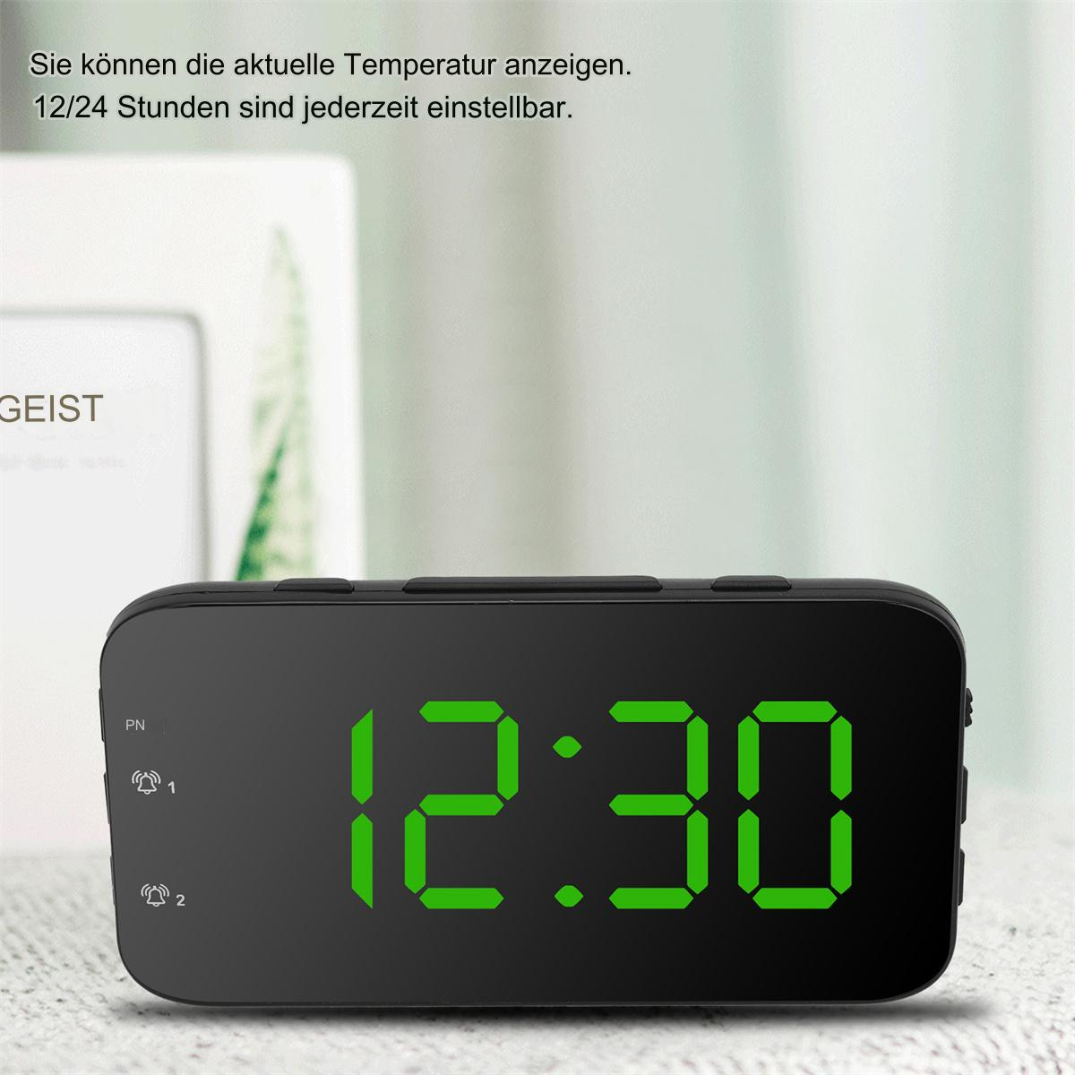 Eine kleine schwarze Digitaluhr, die die Uhrzeit 12:30 anzeigt. Der Text oben besagt, dass die Zeit auf 12 oder 24 Stunden eingestellt werden kann.