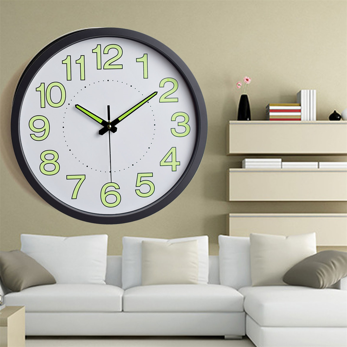 Wanduhr mit schwarzem Rahmen, weißem Zifferblatt und grün leuchtenden Zahlen und Zeigern.