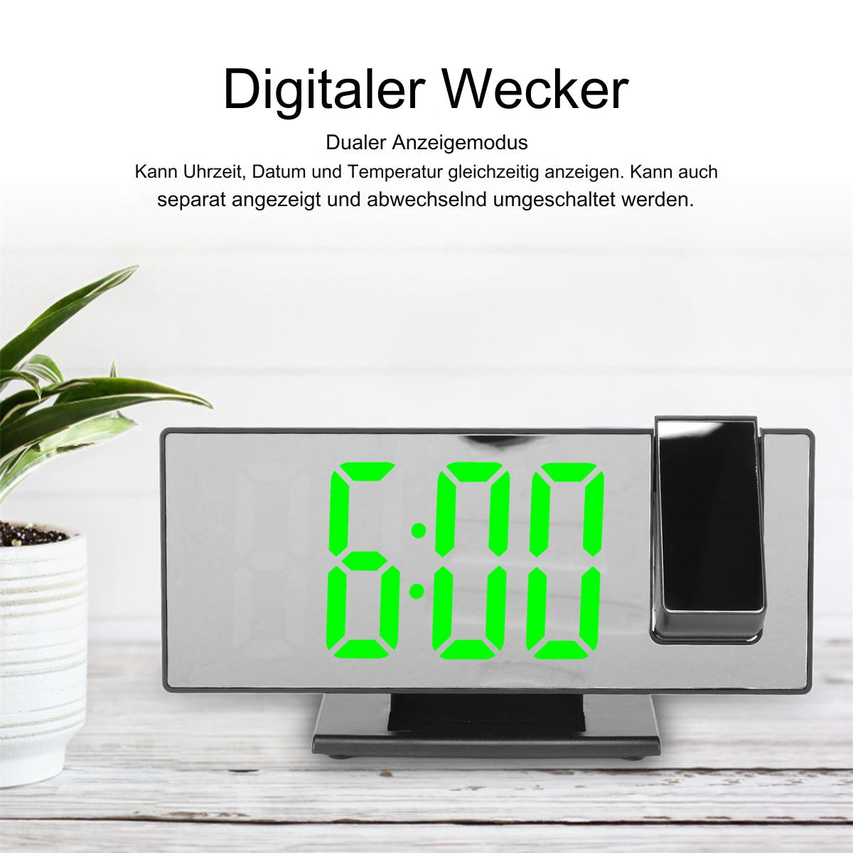 Digitaler Wecker mit 6:00 Uhr. Grüne Ziffern auf verspiegelter Oberfläche.