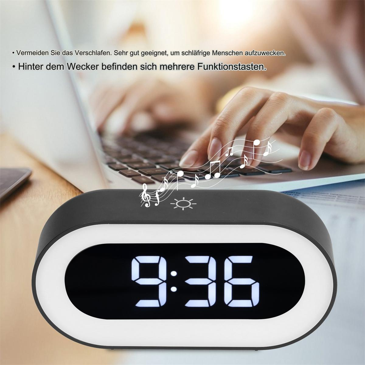 Ein schwarzer Wecker mit weißem Leuchten um die Digitalanzeige, die die Uhrzeit 9:36 zeigt.