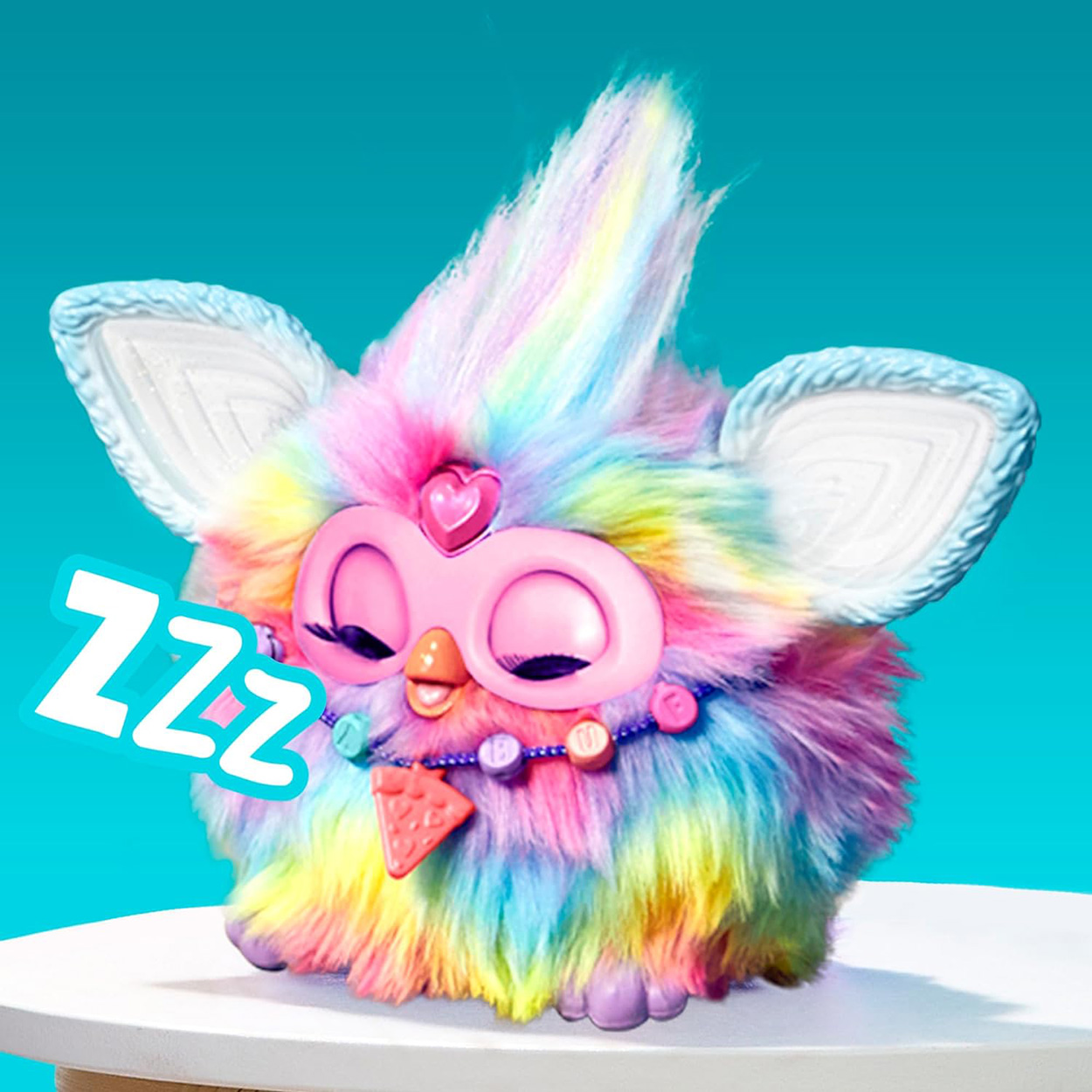 Buntes Furby-Spielzeug mit geschlossenen Augen und einer ZZZ-Textblase.