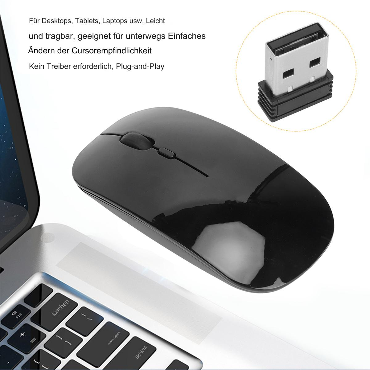 Schwarze kabellose Maus und ein USB-Empfänger neben einer Laptop-Tastatur.