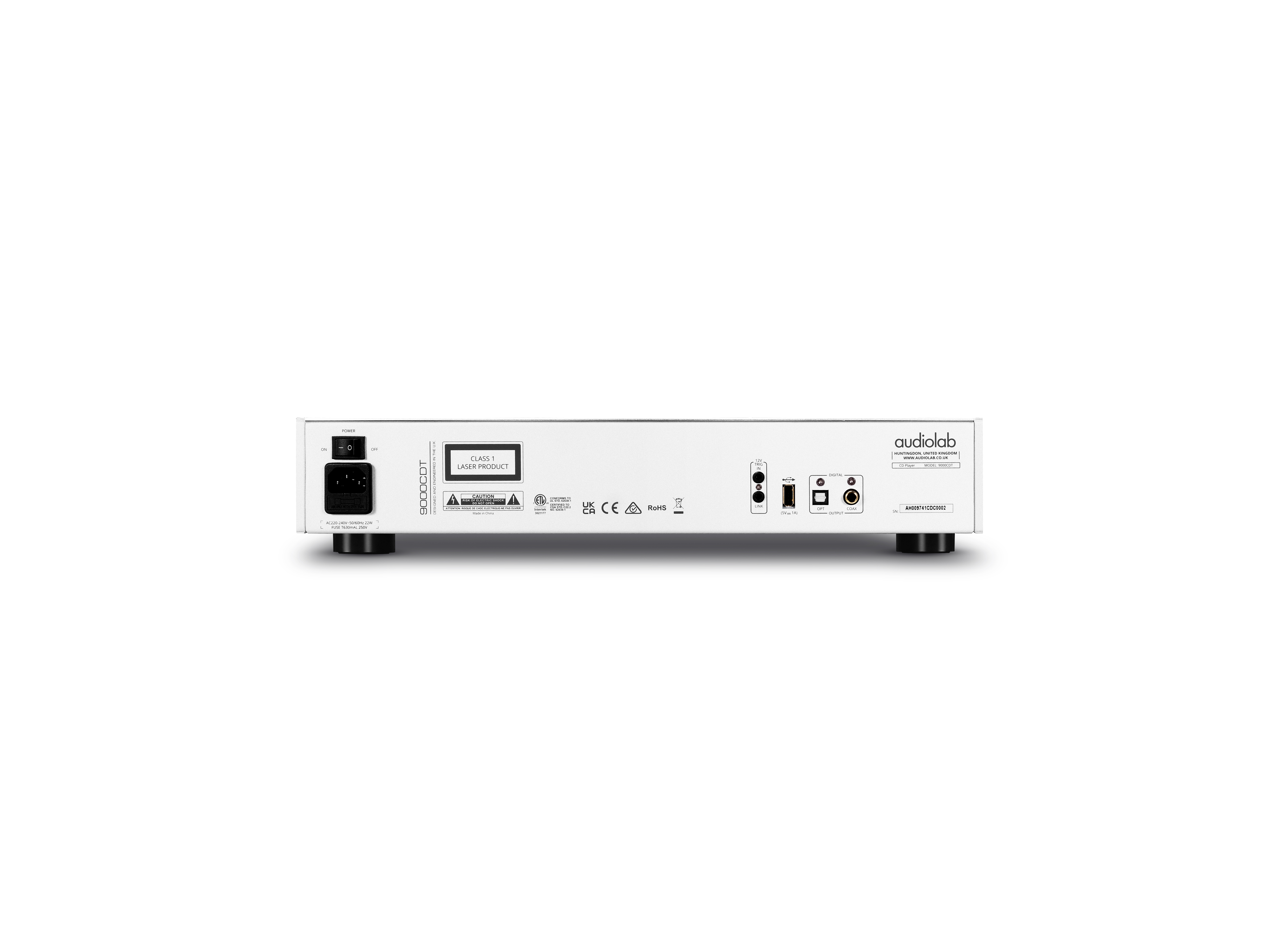 The back of a white audio device with various ports, buttons, and a power plug.