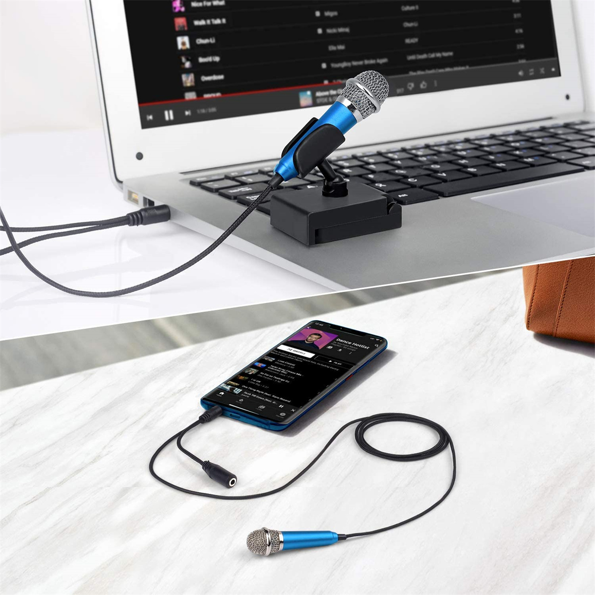 Ein Mikrofon, das mit einem Laptop und einem Smartphone verbunden ist, mit Musik auf dem Telefon.