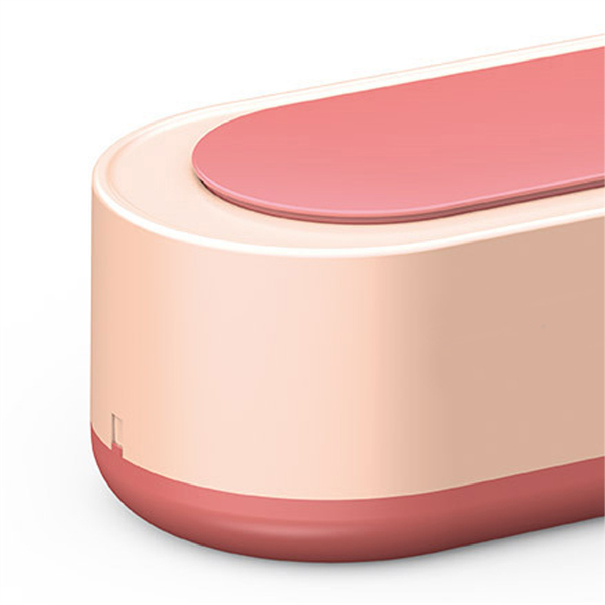 Nahaufnahme eines rosa-weißen Ultraschallreinigers. Die Oberseite ist rosa.