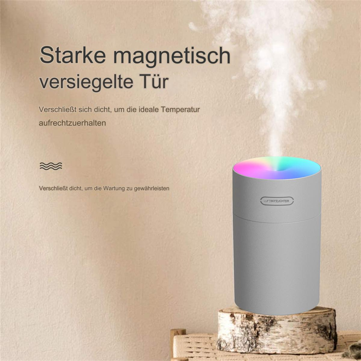 Ein grauer Luftbefeuchter, der farbenfrohen Dampf auf einer Holzoberfläche abgibt.
