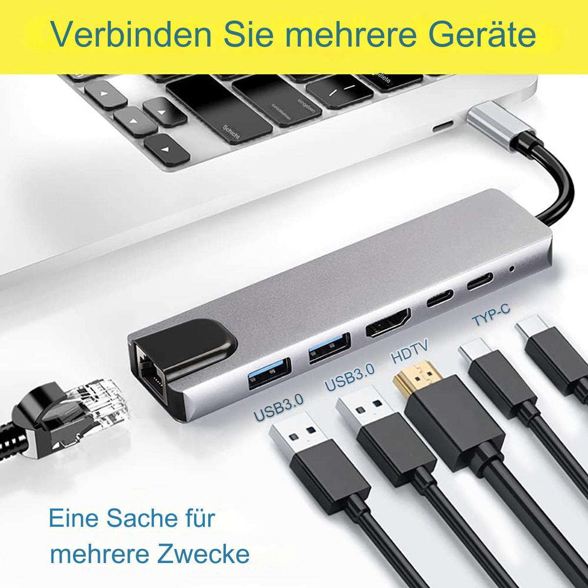 Ein grauer Hub mit mehreren Anschlüssen, die mit einem Laptop verbunden sind, mit verschiedenen Kabeln.