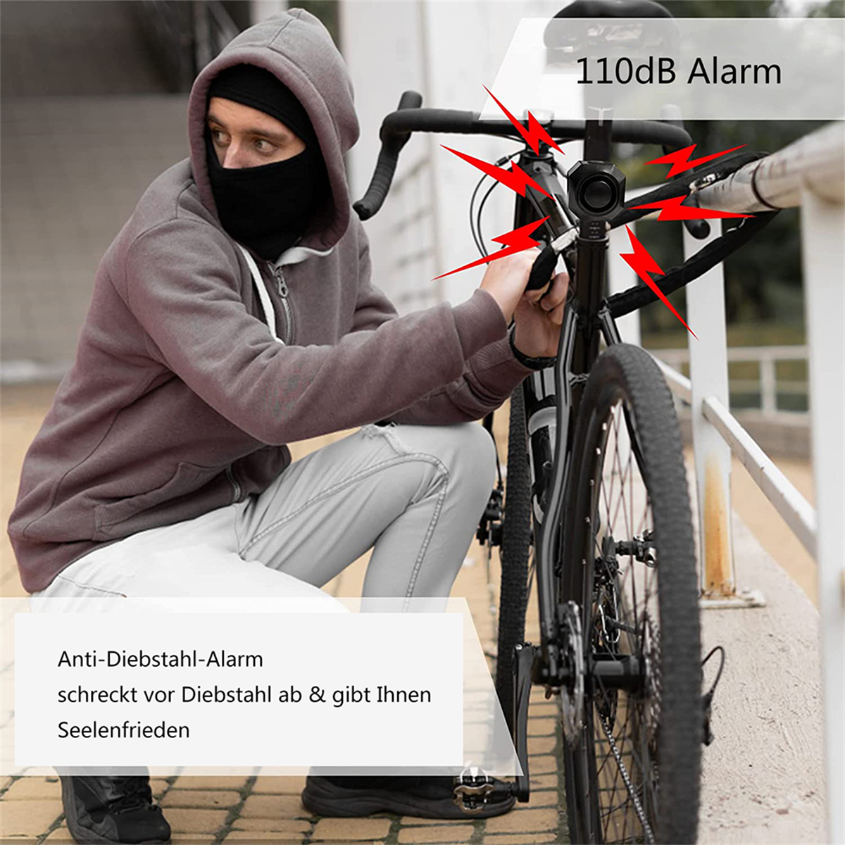 Person mit schwarzer Gesichtsbedeckung in der Nähe eines Fahrrads, mit Alarmsymbolen.