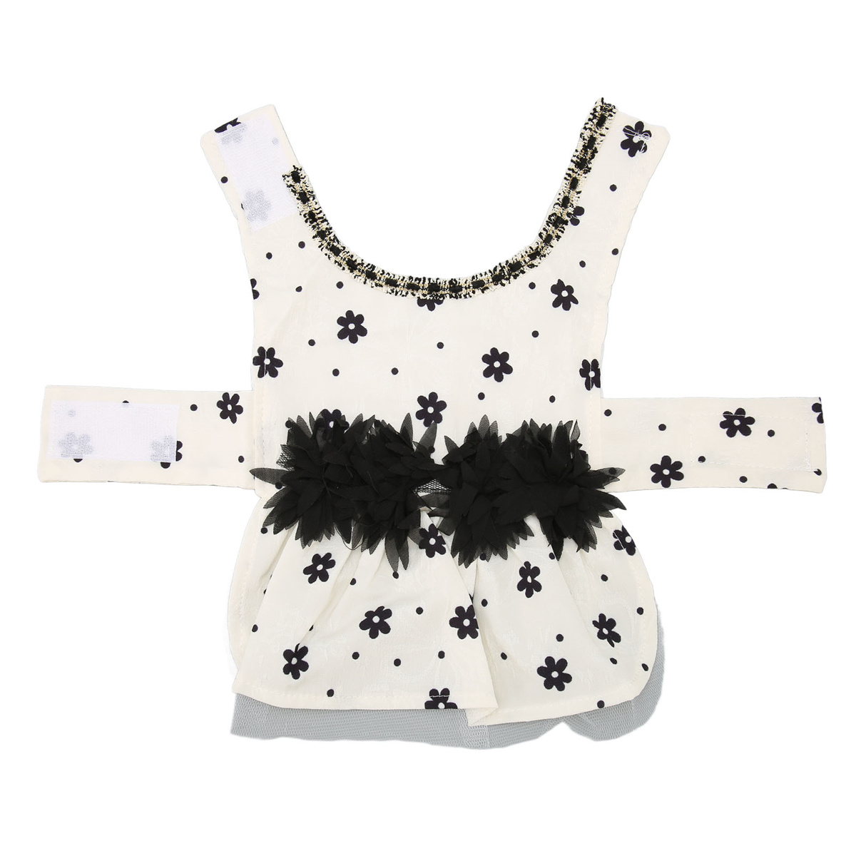 Hundekleid mit weißem Stoff, schwarzen Punkten und schwarzen Blumenornamenten. Das Kleid hat Klettverschlüsse.