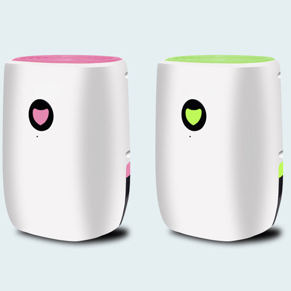 Dwa białe oczyszczacze powietrza, jeden różowy i jeden zielony, z sercowatym wzorem i uśmiechniętą buzią.