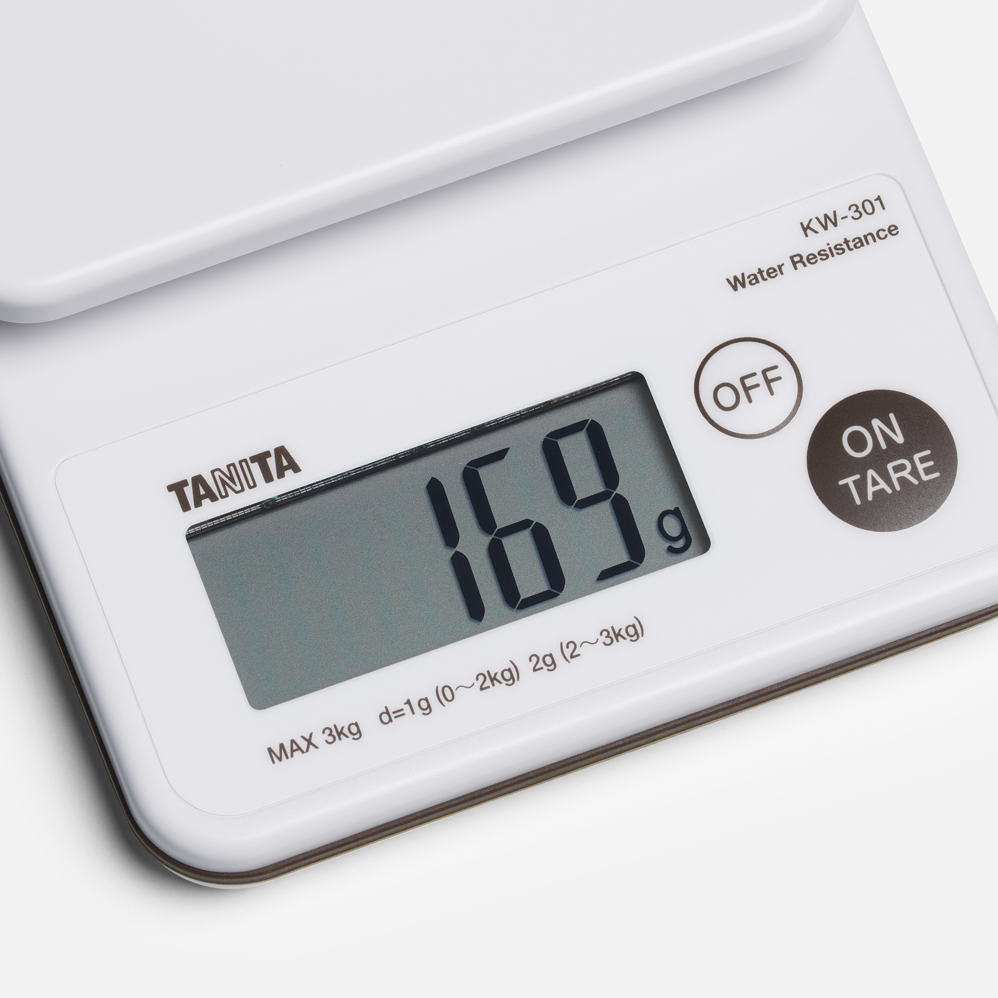 Een digitale keukenweegschaal met een display die 169g weergeeft. Heeft aan/uit en tare knoppen.