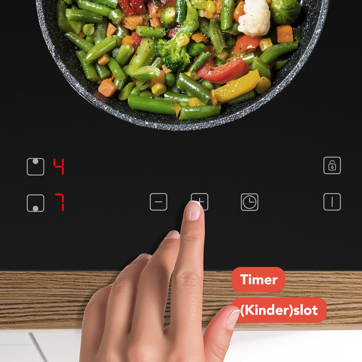 Cooking on induction hob, hand presses timer button, vegetables in pan.
