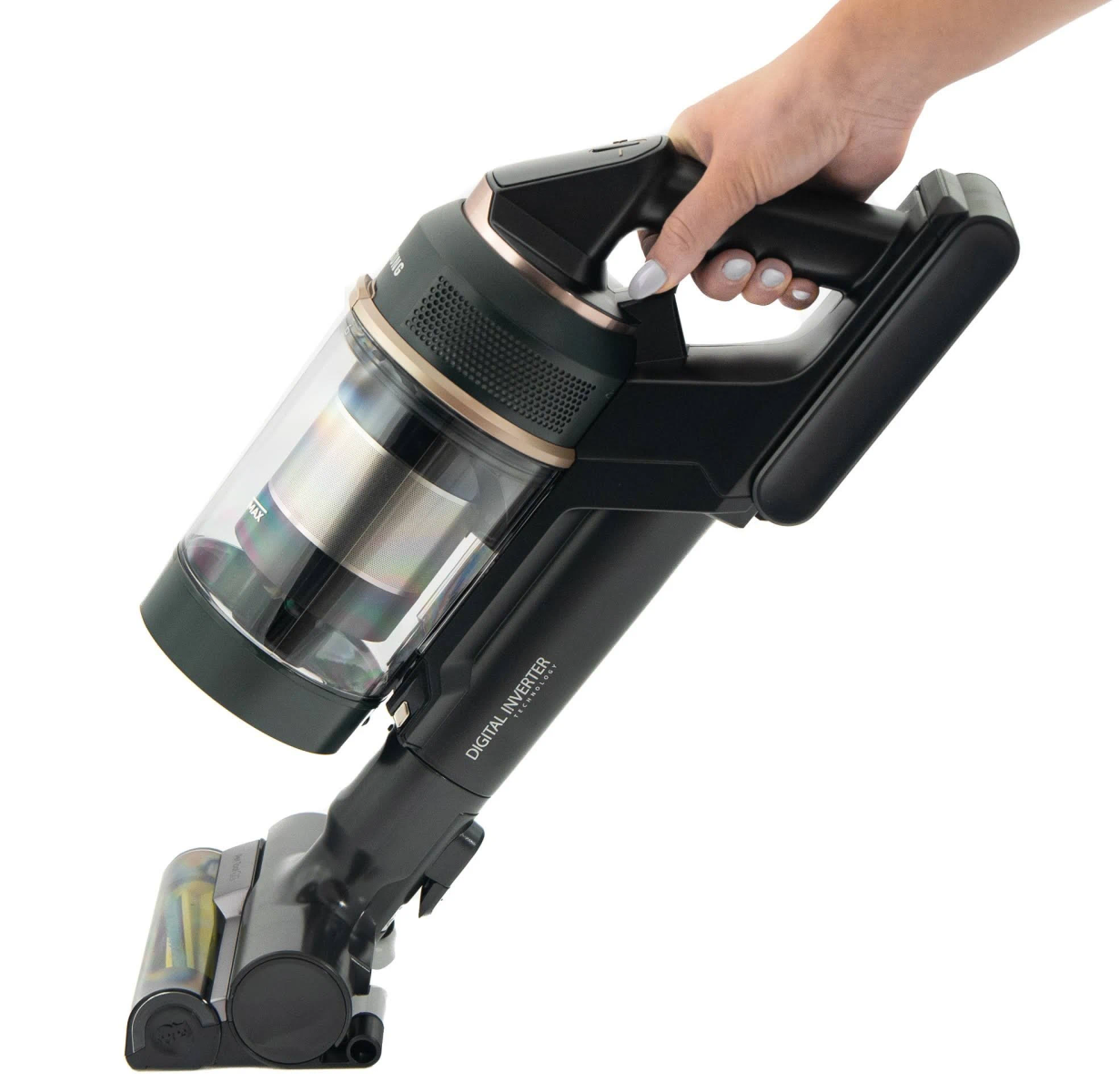 A hand holding a black and green vacuum cleaner, isolated on white.
