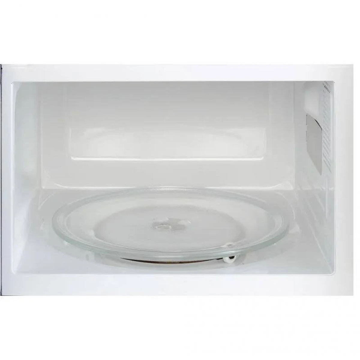 De binnenkant van een witte magnetron. Er is een glazen plaat zichtbaar.