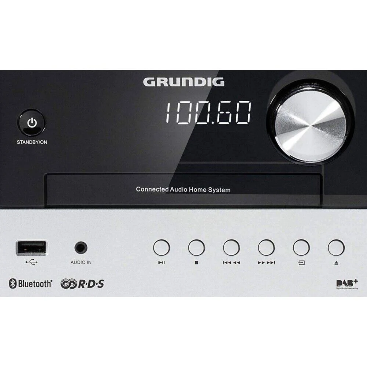 Sistema de audio Grundig negro y plateado. La pantalla muestra 100.60. Tiene botones de encendido, Bluetooth y más.