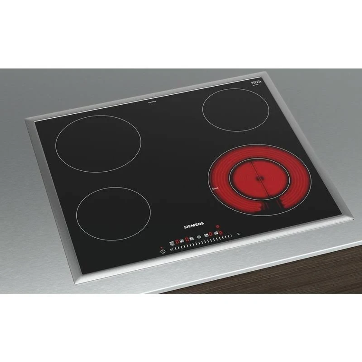 Czarna płyta elektryczna z czterema palnikami, jeden czerwony.