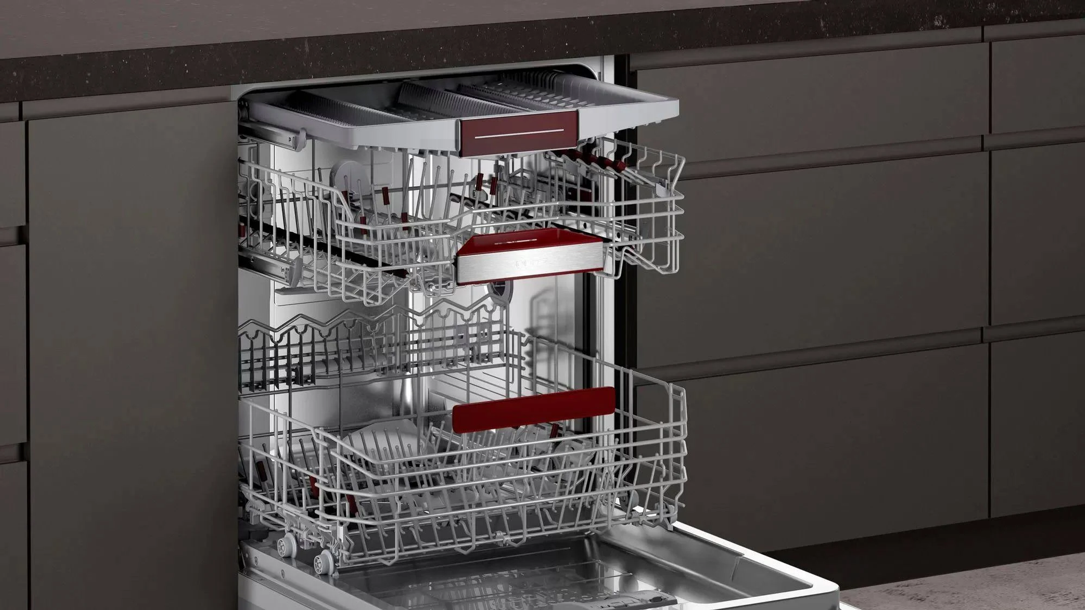 Dishwasher interior with two levels of racks. Red accents. Dark, neutral background.