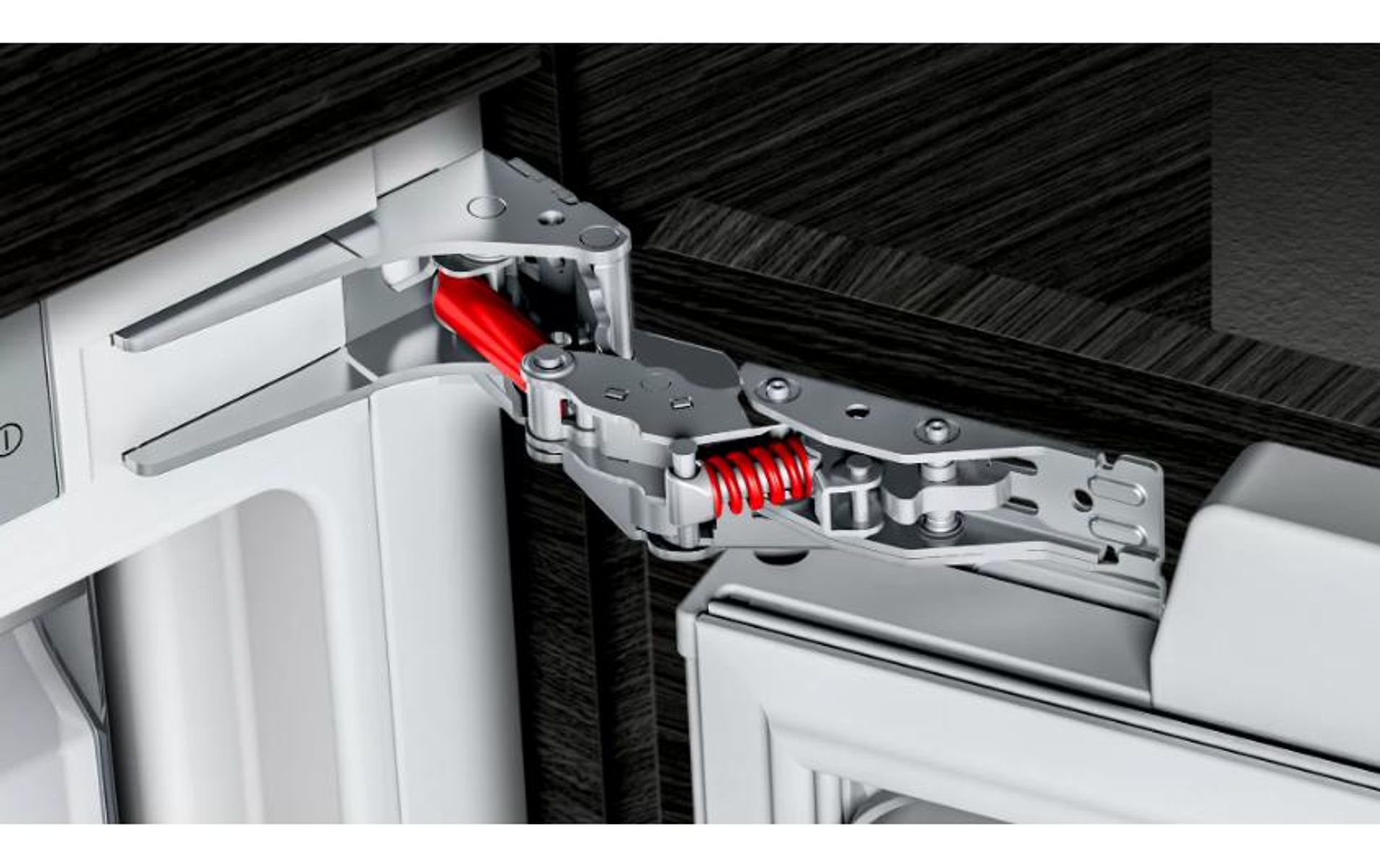 Close-up van een koelkastonderdeel. Het bestaat uit een metalen arm met een rode veer.
