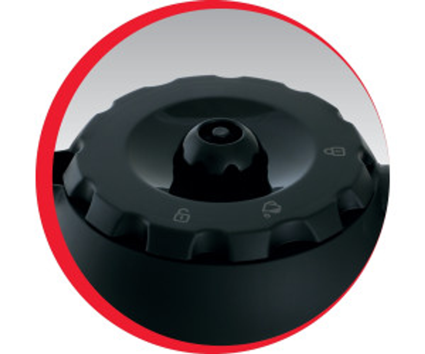 Zbliżenie czarnego pokrętła z symbolami i numerami. Pokrętło jest w czerwonym okręgu.