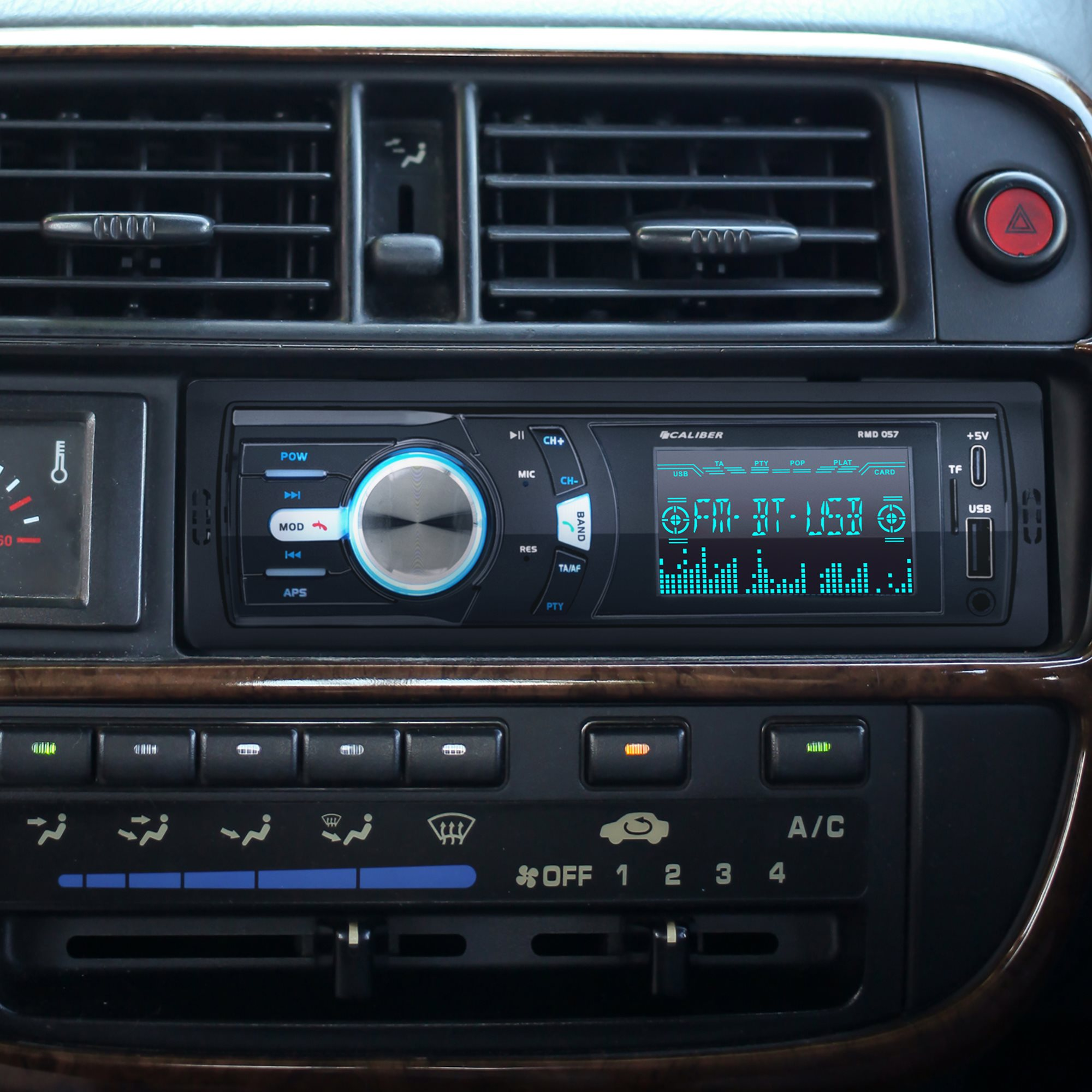 Car stereo system. Black plastic with a digital display. Buttons, dials, and USB port. 