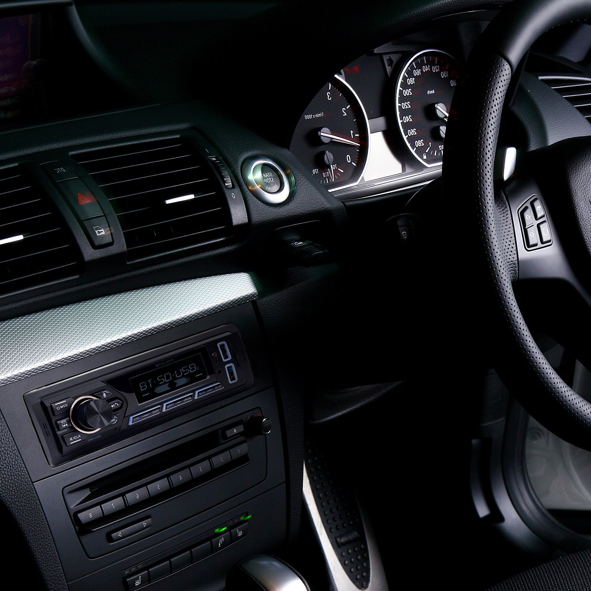 Car interior shot with dashboard, steering wheel. Radio and gauges visible.