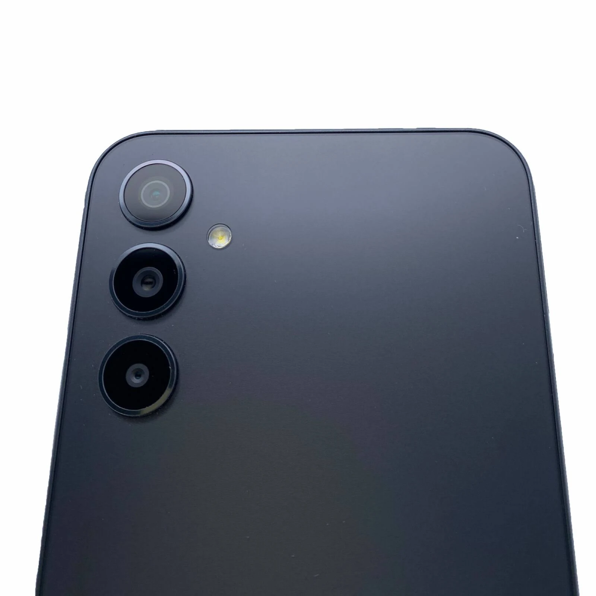 Primer plano de la configuración de triple cámara de un teléfono inteligente negro.