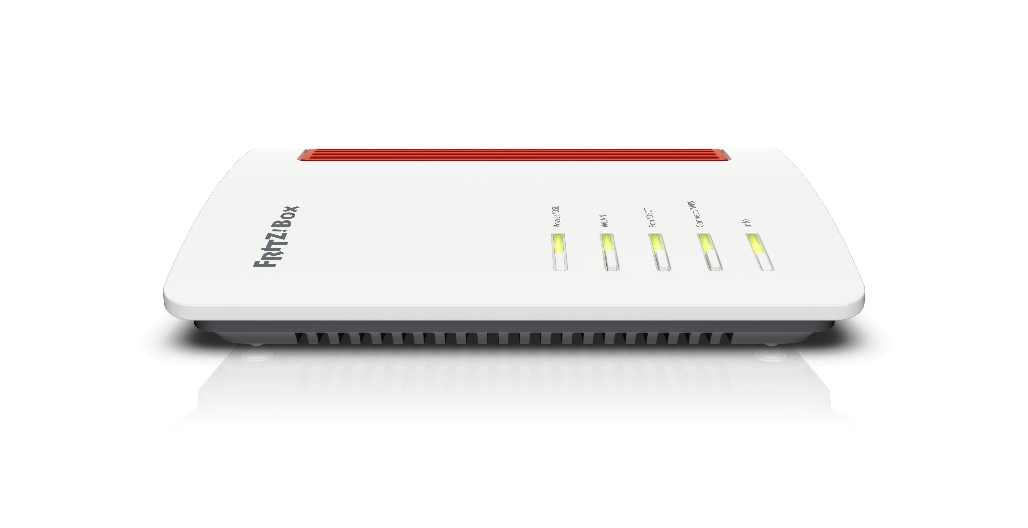 Biały router z czerwonymi akcentami, widok z góry, na białej powierzchni.