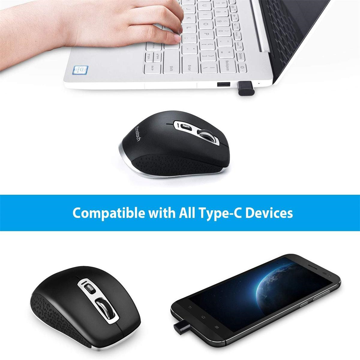 Schwarze Maus neben Laptop und Handy. USB-Empfänger sichtbar.