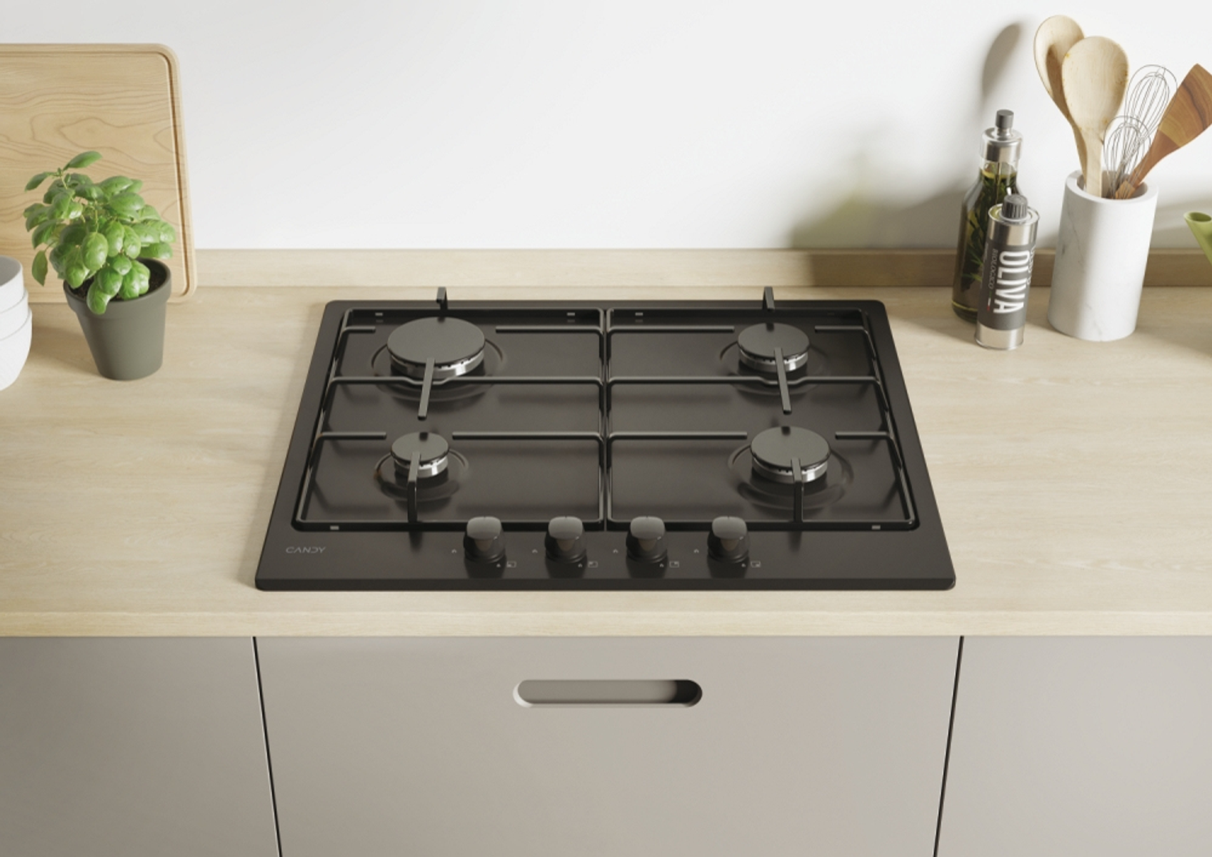 Czarna płyta grzewcza z czterema palnikami i pokrętłami, ustawiona na jasnym drewnianym blacie.