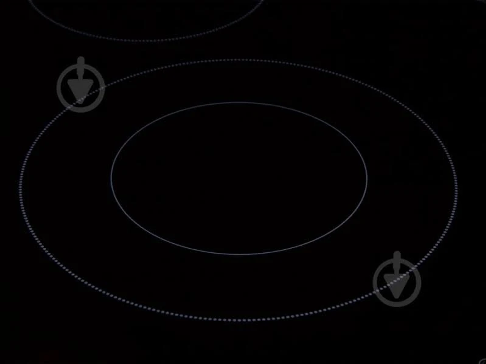 Zbliżenie czarnej płyty indukcyjnej, pokazujące dwie strefy gotowania z kropkowanymi okręgami.