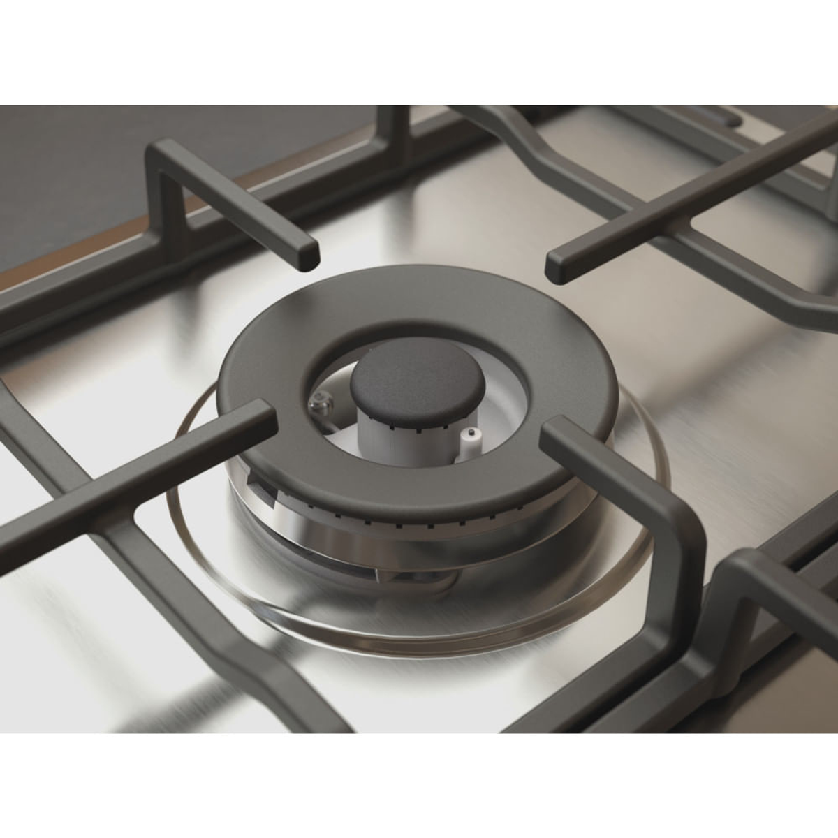 Zbliżenie palnika kuchenki gazowej ze stali nierdzewnej z czarnym środkiem.