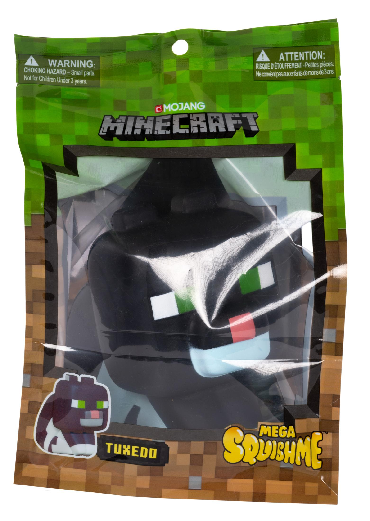 Ein Minecraft-Spielzeug, ein schwarz-weißes Tuxedo Squishme, in einer grünen Verpackung.