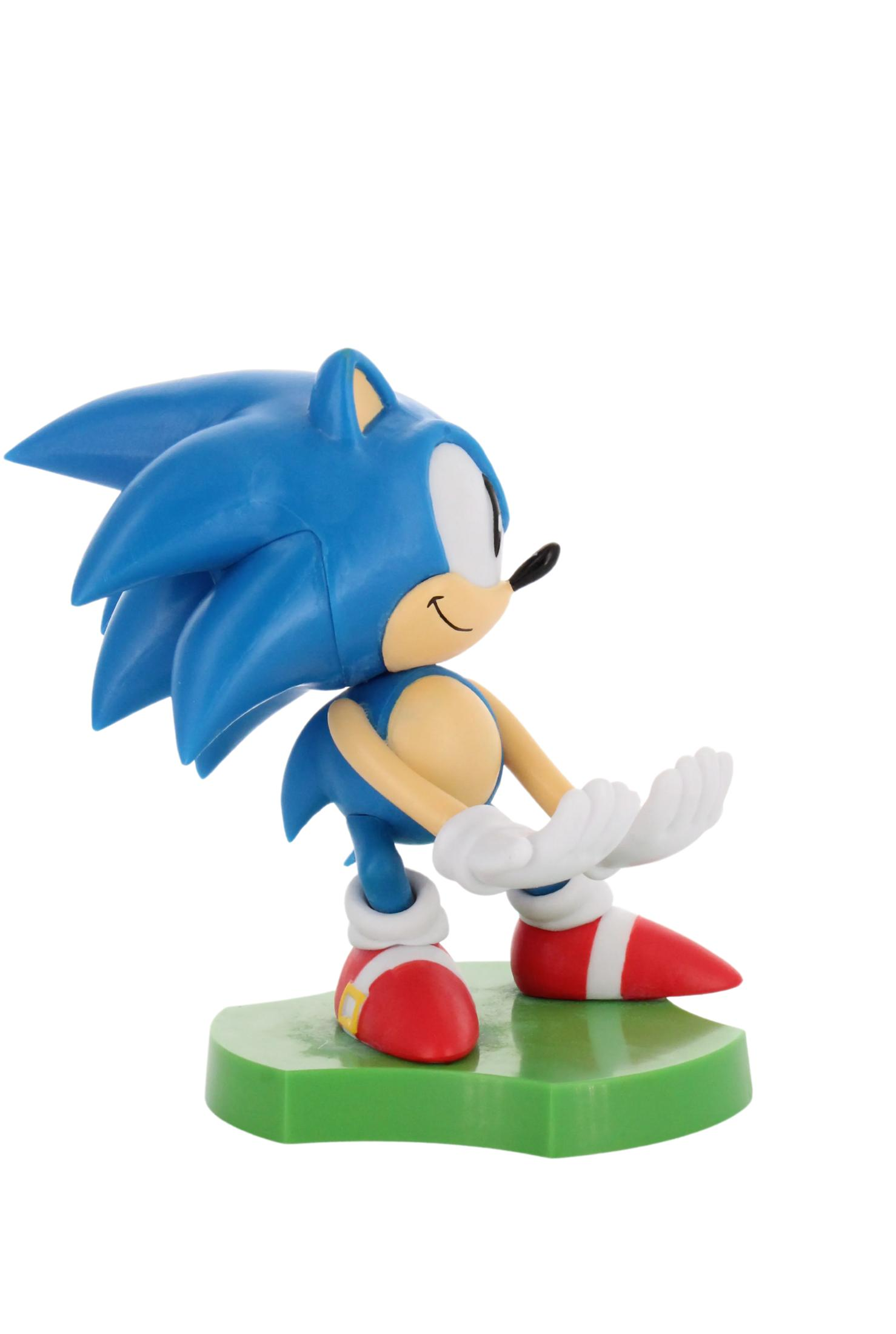 Statuetta di Sonic the Hedgehog in posa di corsa, blu e bianco, con base verde.