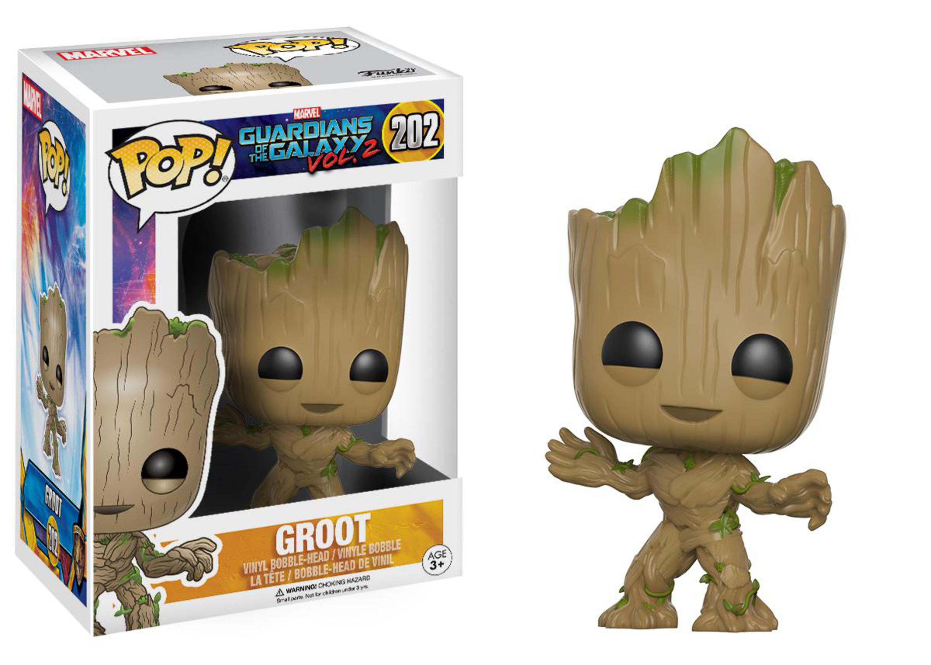 Groot-Figur in der Box, Groot außerhalb der Box. Groot ist braun mit grünen Ranken, lächelnd.