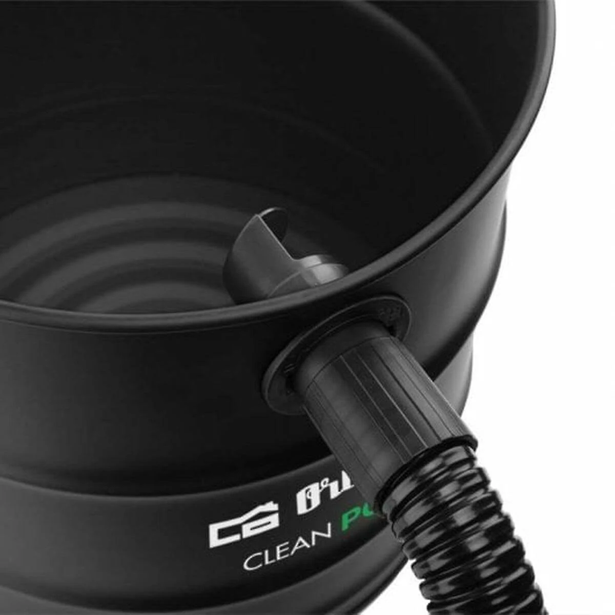 Close up of a black vacuum cleaner with a hose attached to the side.