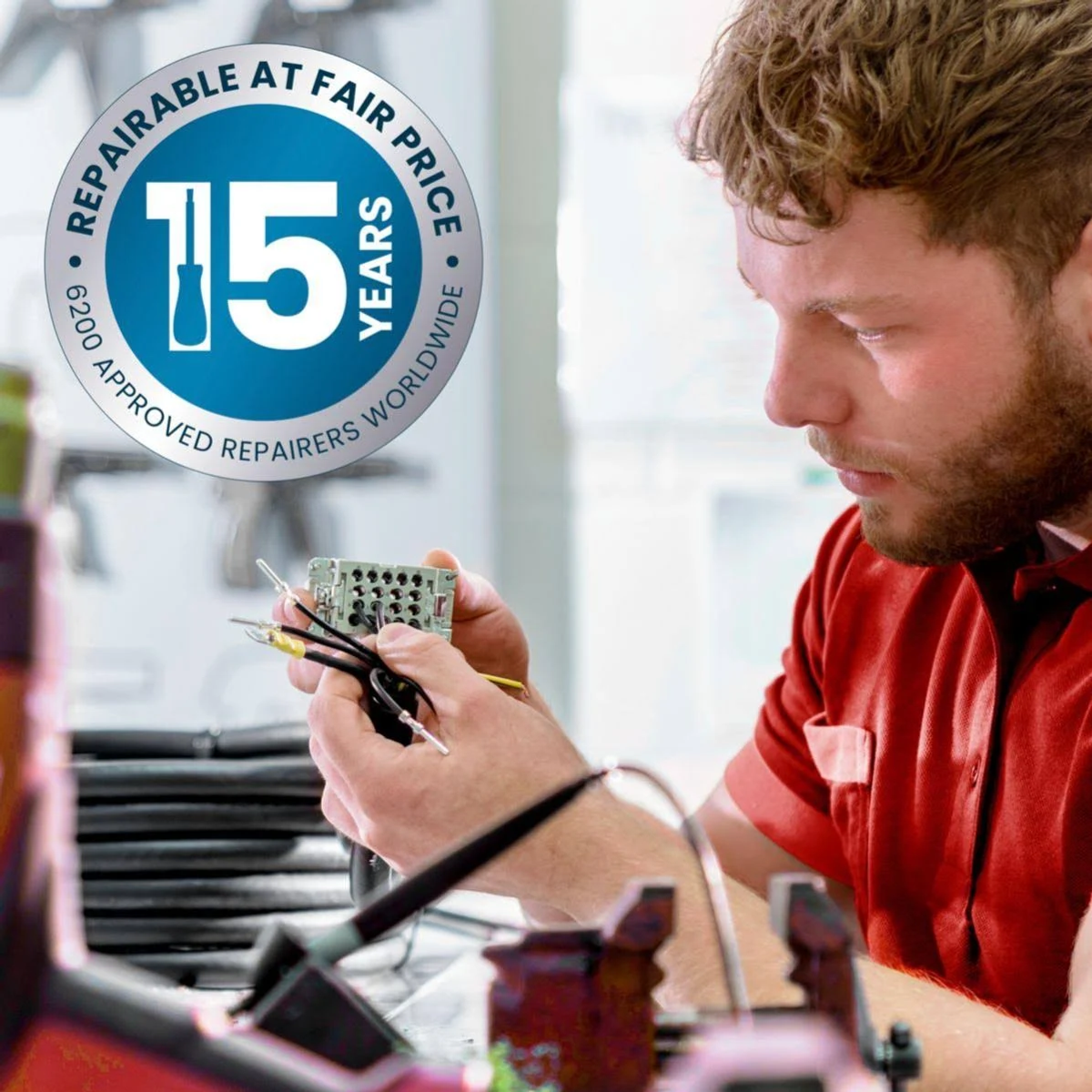 Mężczyzna naprawia element elektroniczny, z logo 'REPAIRABLE AT FAIR PRICE'.