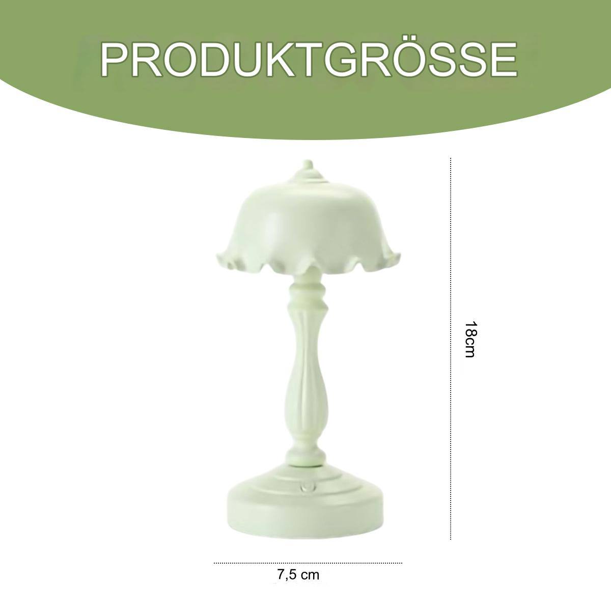 Kleine, weiße, pilzförmige Lampe. Abgerundete Oberseite mit Rüschenrand. Auf weißem Sockel.