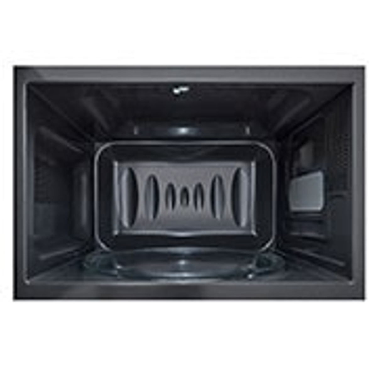 Wewnątrz ciemnej kuchenki mikrofalowej. Szklany talerz jest na środku.