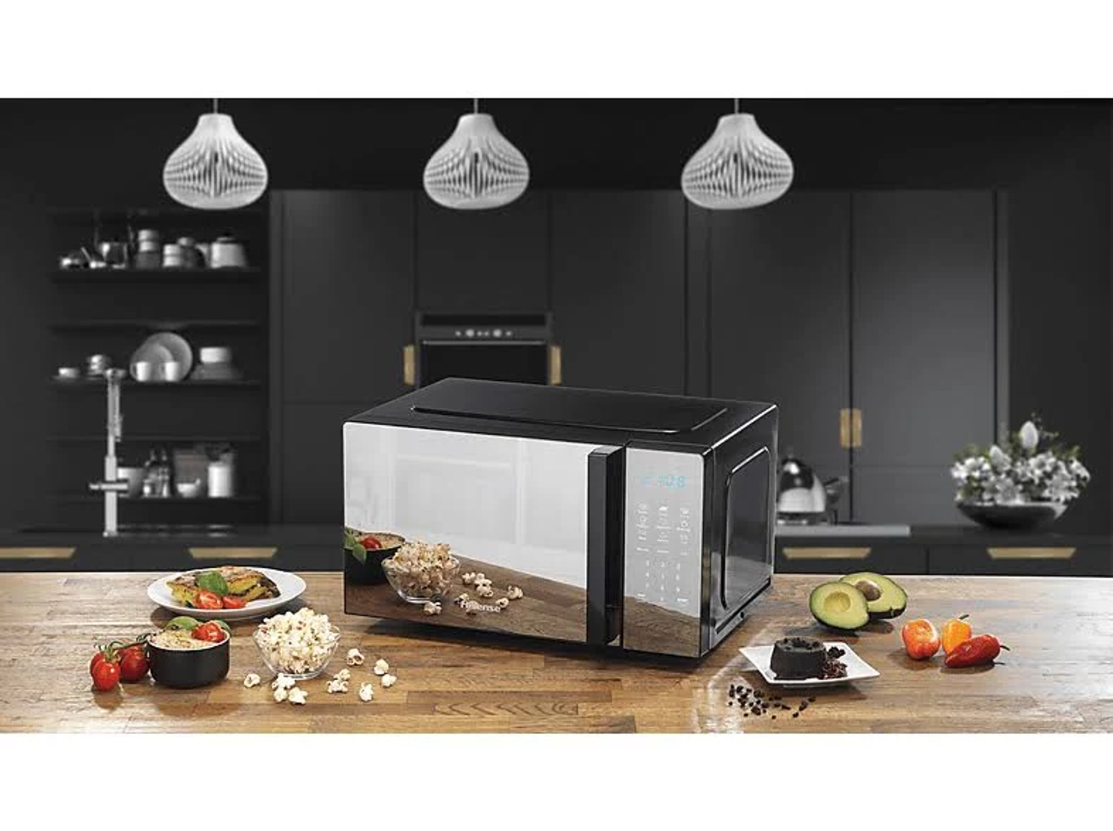 Czarna kuchenka mikrofalowa. Różne produkty spożywcze, takie jak popcorn i awokado. Nowoczesne tło kuchni.