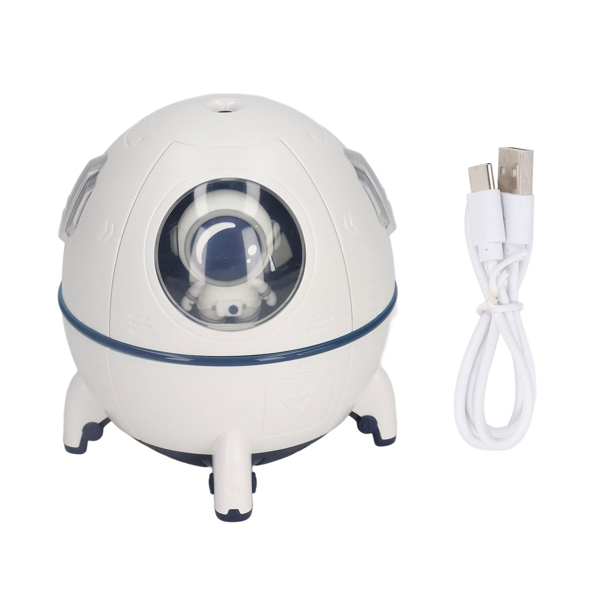 Weißer raketenförmiger Luftbefeuchter mit Astronauten, USB-Kabel daneben.