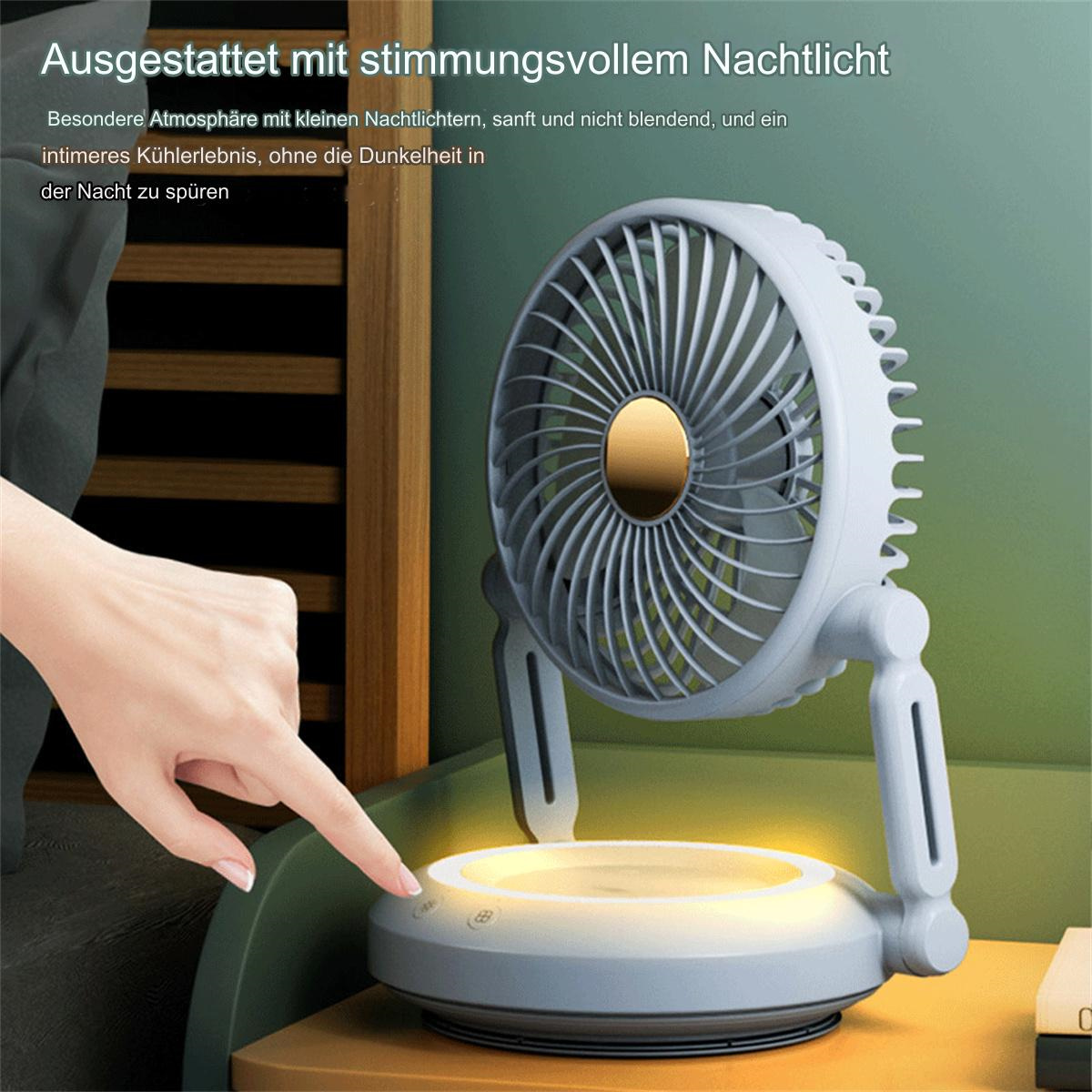 Ein kleiner Ventilator mit Licht, eine Hand drückt einen Knopf. Er steht auf einem Tisch.