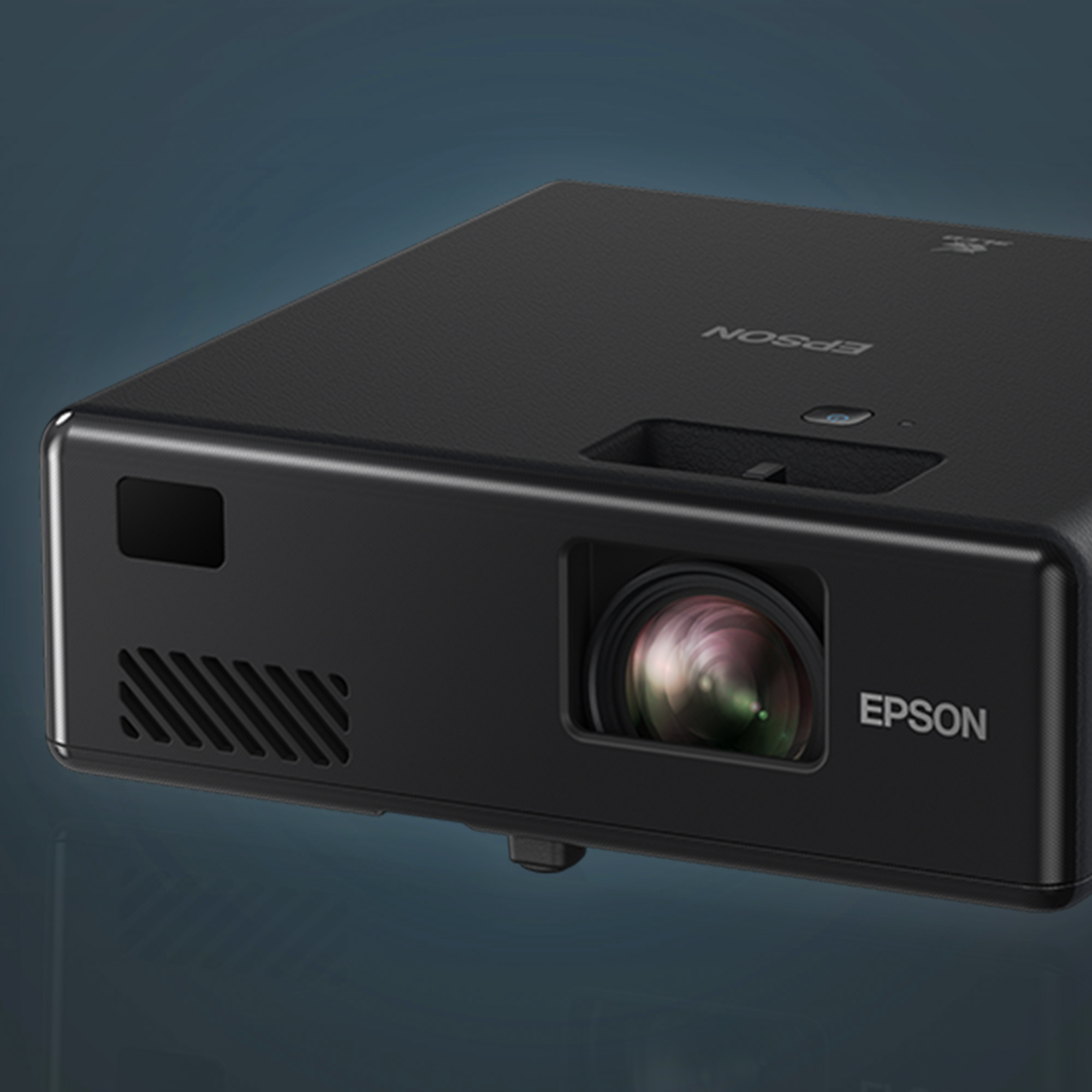 Proiettore Epson nero. Obiettivo e prese d'aria visibili. Sfondo sfumato scuro.