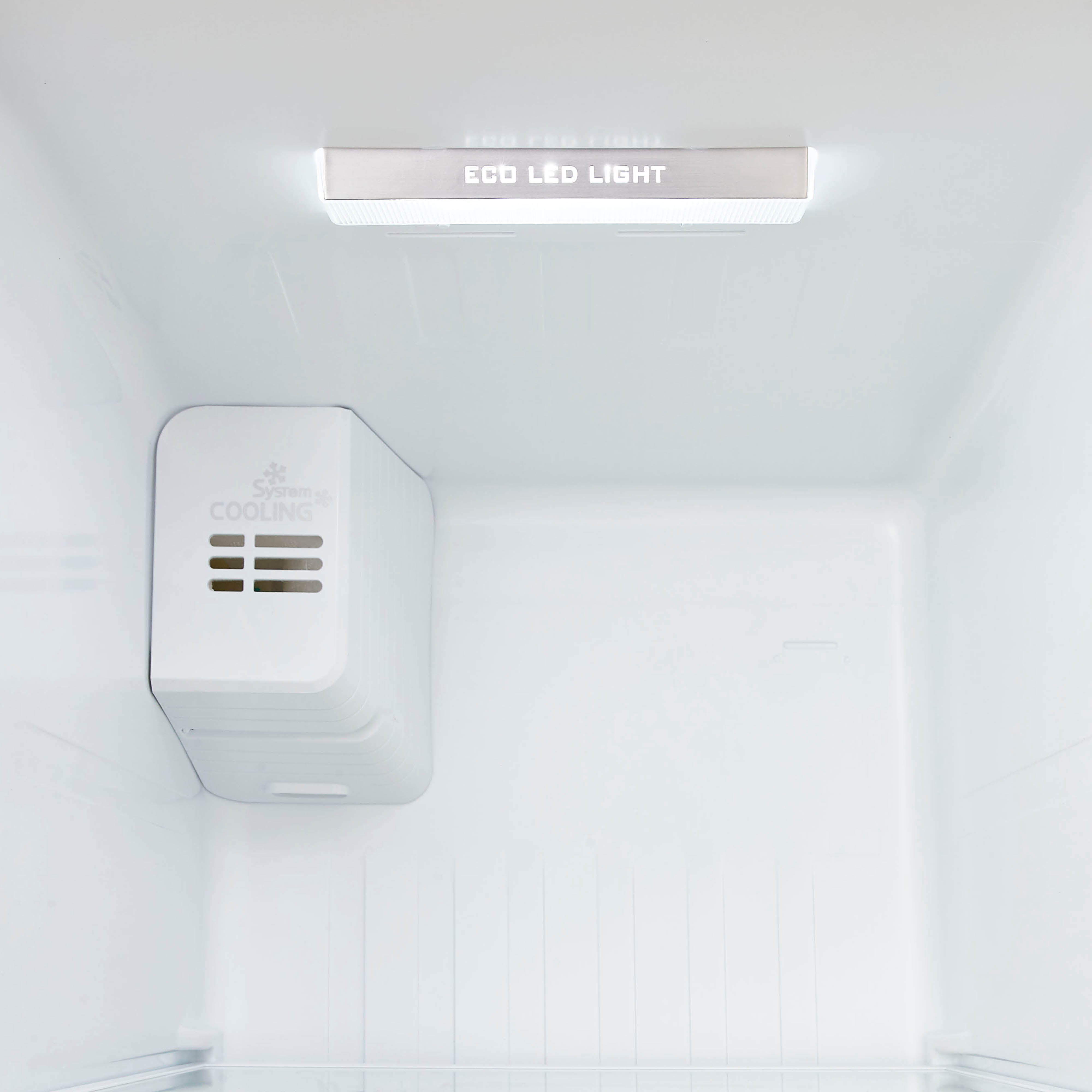 Inside a white fridge. An LED light is on top. A cooling system is at the left.